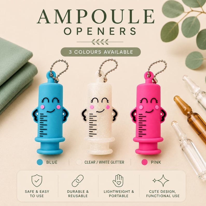 May include: Three ampoule openers shaped like syringes with smiling faces, available in blue, clear white glitter, and pink. Each opener features a small metal ball chain for attachment and includes printed markings. The text reads AMPOULE OPENERS.