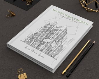 Może przedstawiać: Biały notatnik z architektonicznym szkicem i tekstem "ARCHITECTURAL CONCEPTS Design Development". Zawiera złote i czarne ołówki oraz złote spinacze do papieru. Notatnik ma tekst "Your Name here".