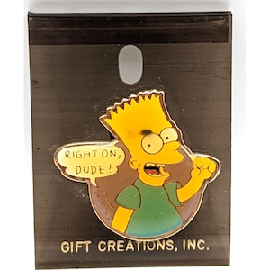 May include: A yellow cartoon character with spiky yellow hair, wearing a green shirt, is holding up his fist and saying "Right on, dude!" in a speech bubble. The pin is on a black background with the text "Gift Creations, Inc."