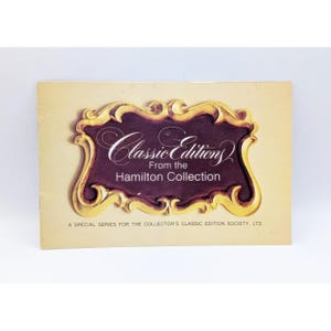 May include: A gold-framed card with a burgundy background and the text "Classic Editions From the Hamilton Collection" in a gold script font. The card also includes the text "A Special Series for the Collector's Classic Edition Society, LTD."