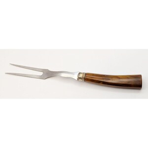 May include: A stainless steel carving fork with a brown marbled plastic handle.