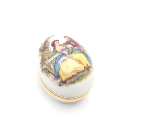 A genuine vintage Limoges hand-painted porcelain egg box with a courting couple scene — the kind of tiny heirloom you find at a French antique market.