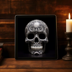 May include: A black and white sugar skull with intricate floral designs on a tablet screen. The tablet is on a wooden surface.