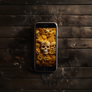 May include: A smartphone displaying a wallpaper of sugar skulls and yellow flowers. The phone is on a dark wood surface.