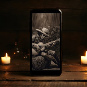 May include: A black and white digital illustration of a skeleton wearing a sombrero and playing a guitar. The image is displayed on a smartphone screen.