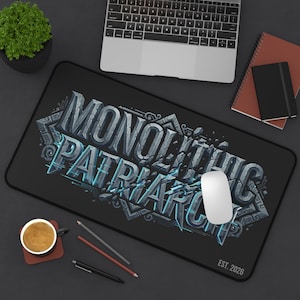May include: Black rectangular mousepad with the words "MONOLITHIC PATRIARCH" in a gray, blue, and white 3D design. A white computer mouse sits on the pad. The text "EST. 2026" is in the lower right corner.