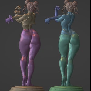 May include: A 3D printed figurine of a female figure with a muscular build, wearing a yellow and purple outfit. The figure is posed with one arm raised and the other arm bent at the elbow. The figure is standing on a circular base.