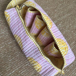 Handmade lemon print hair styling organizer with four padded compartments.
