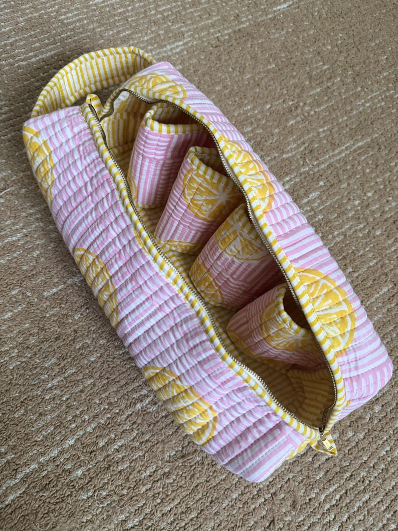 Handmade lemon print hair styling organizer with four padded compartments.