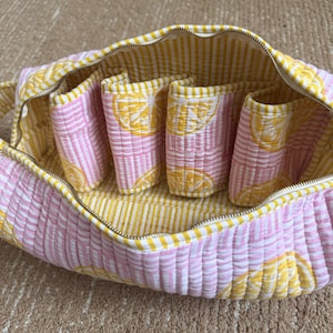Lemon block print quilted organizer with spacious interior and carry handle.