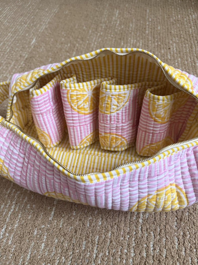 Lemon block print quilted organizer with spacious interior and carry handle.