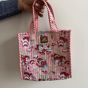 Pink floral hand block printed quilted mini tote bag with red striped binding and padded cotton handles