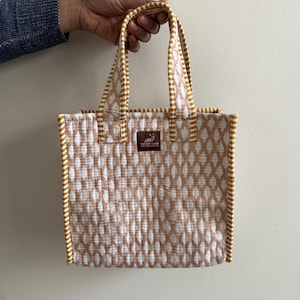 Beige block printed quilted mini tote bag with mustard striped trim, reusable cotton lunch bag with handles.