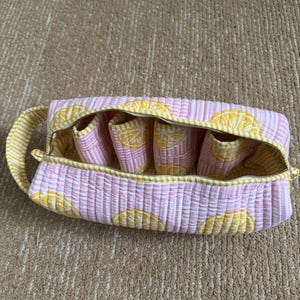 Cotton travel storage bag with zipper closure for hair styling tools.
