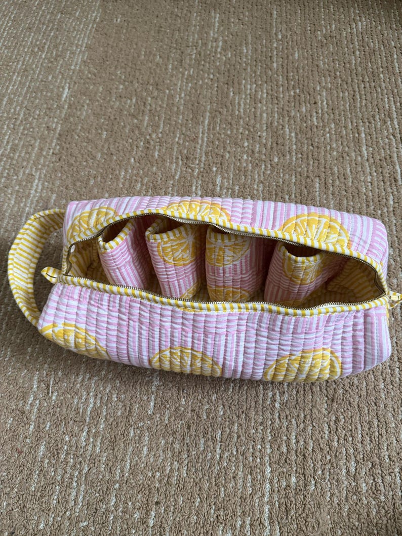 Cotton travel storage bag with zipper closure for hair styling tools.