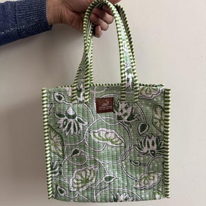 Sage green floral block printed quilted mini lunch tote with striped binding and sturdy padded cotton handles.