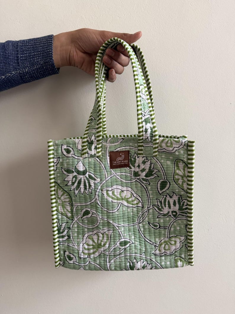 Sage green floral block printed quilted mini lunch tote with striped binding and sturdy padded cotton handles.
