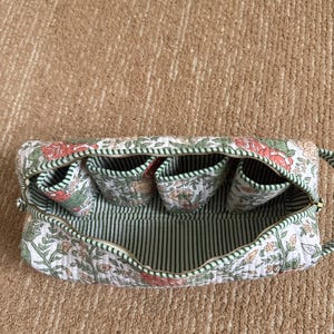 Green floral quilted organizer for Dyson Airwrap accessories and styling tools.