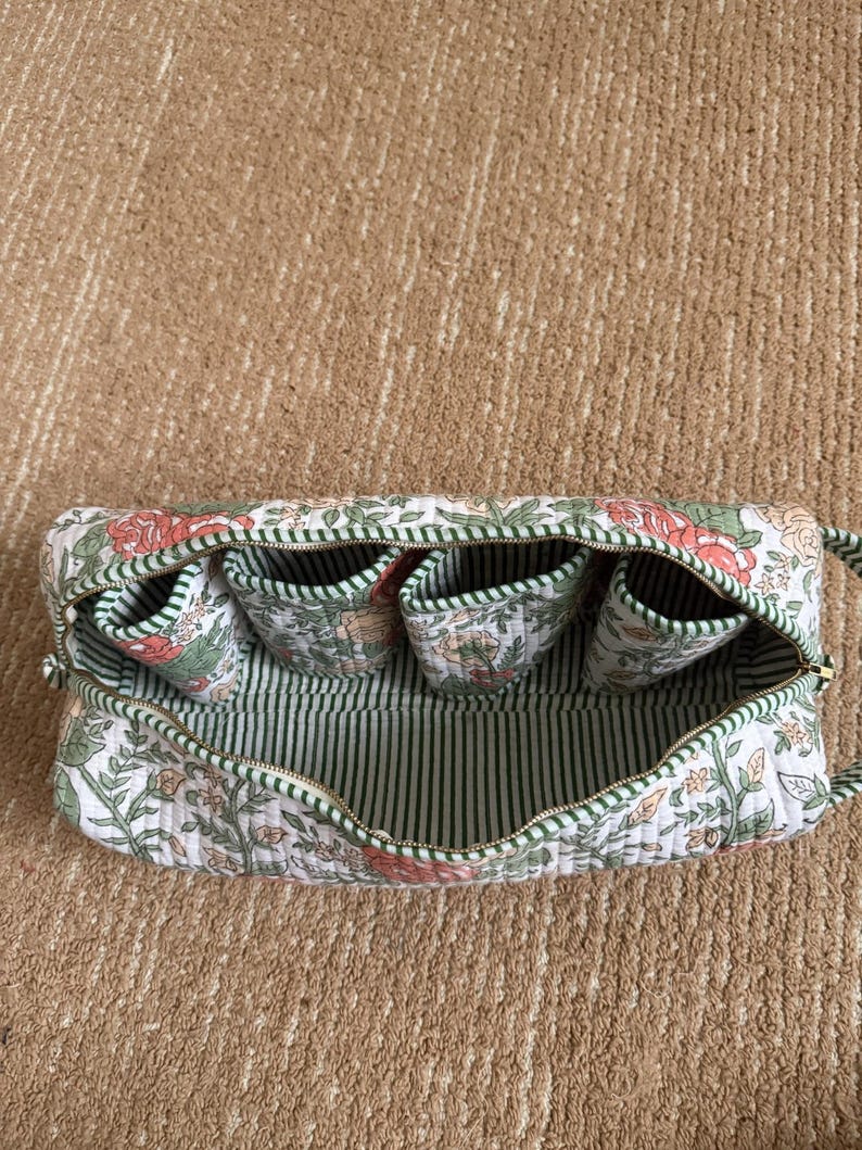 Green floral quilted organizer for Dyson Airwrap accessories and styling tools.