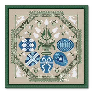 May include: A cross stitch pattern featuring a blue and white Easter egg design with a floral motif and bunnies. The pattern is framed in a green border.