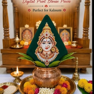 May include: A dark green fabric piece featuring a detailed digital print of the goddess Mahalakshmi, adorned with gold jewelry and red accents. The fabric is shaped into a cone and placed atop a copper pot, surrounded by marigold flowers.