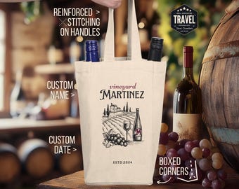 May include: A white canvas wine tote bag with reinforced stitching on the handles. The bag features a vineyard illustration with the text "vineyard MARTINEZ" and "ESTD. 2024". The bag has boxed corners.