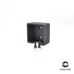 May include: A black plastic wall mount with two screw holes and two screws. The mount is designed to hold a device or object.