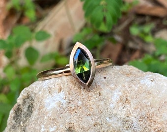 14k red gold ring set with a green marquise tourmaline stone