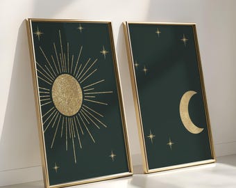 May include: Two framed prints with a dark green background and gold accents. The first print features a stylized sun with a gold glitter texture and rays of light. The second print features a crescent moon with a gold glitter texture and stars.