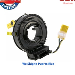 May include: Black steering wheel column switch with yellow wiring connectors. The switch has a circular shape and a black plastic housing. The switch is designed for use in automobiles.