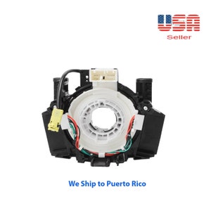 May include: A black steering wheel column switch with a white plastic ring and a yellow connector. The switch has a variety of wires connected to it.