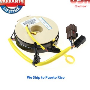 May include: A yellow and black steering wheel clock spring with a beige plastic housing. The clock spring has a label that reads "PART NUMBER: 55311-S5A-A01".