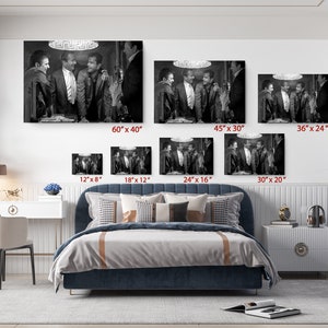 a bed room with a neatly made bed and pictures on the wall