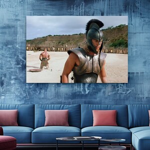 a living room with a blue couch and a painting on the wall
