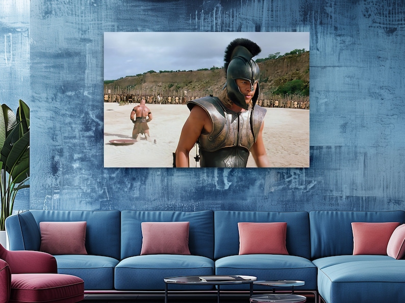 a living room with a blue couch and a painting on the wall