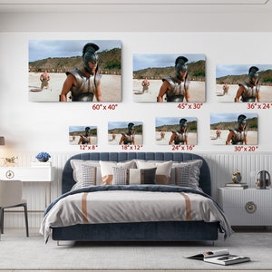 a bed room with a neatly made bed and pictures on the wall