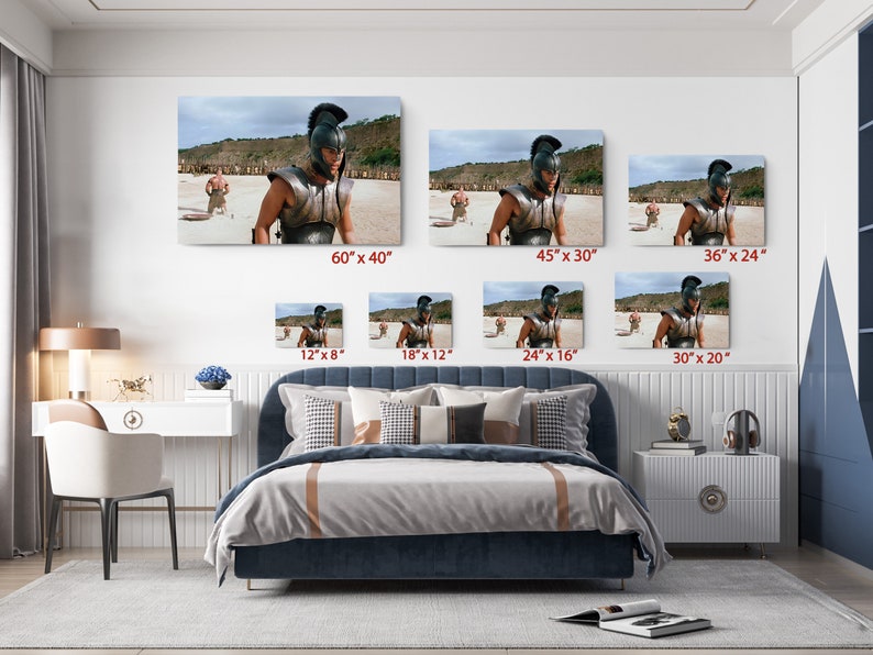a bed room with a neatly made bed and pictures on the wall