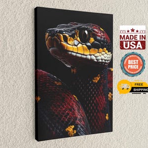 May include: A canvas print featuring a close-up of a snake's head and body. The snake has a yellow and black head with red and black scales on its body. The canvas is rectangular and mounted on a black frame. The words "MADE IN USA" are visible.