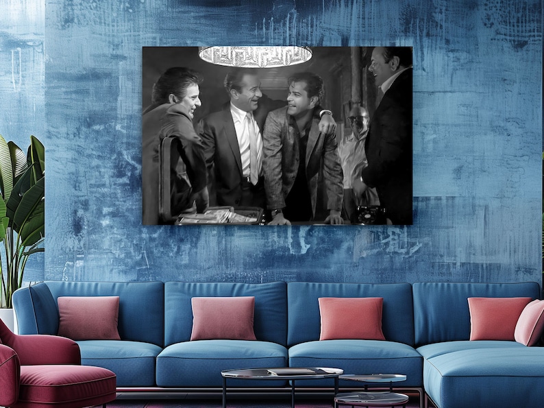 a living room with a blue couch and a painting on the wall