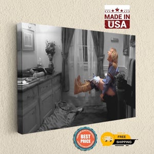 May include: A black and white canvas print depicting a scene from a bathroom with a person wearing a blue shirt and tan boots, appearing to be in mid-air or falling. The room features a vanity, a window with curtains, and a towel rack.