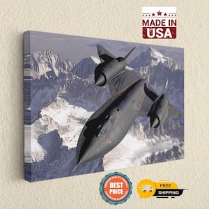 May include: A rectangular canvas wall art print featuring a black SR-71 Blackbird aircraft flying over snow-capped mountain peaks. The image displays the jet in flight with its distinct dual engine nacelles and sharp nose profile against a rugged terrain.