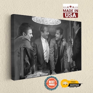 a black and white photo of three men talking