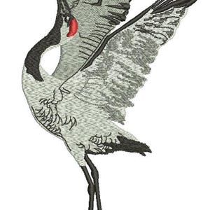 May include: An embroidered design of a crane in flight, featuring gray and white feathers with black accents on the wings and legs. The crane has a black neck and a red patch near its beak. The design is on a white background.