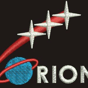 May include: Embroidered patch with the word "ORION" in white, a blue planet with a red ring, and a red trail leading to three white stars on a black backdrop. The design has a space or science fiction theme.
