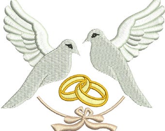 May include: Two white doves with outstretched wings, facing each other, with two gold wedding rings intertwined below them. A white ribbon with a bow is tied around the rings.