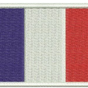 May include: Embroidered rectangular patch featuring the French flag. The design includes vertical stripes in blue, white, and red, with a white border. The patch is likely for clothing or accessories.