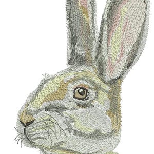 May include: An embroidered image of a rabbit's head in profile. The rabbit has long ears, a light brown eye, and a detailed texture with shades of gray, tan, and pink. The image is set against a white background.