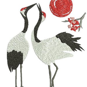 May include: Embroidered design featuring two Japanese cranes with red crests, black and white plumage, and long legs. A red sun and a branch with pink flowers are also included in the design. The artwork is set against a white background.