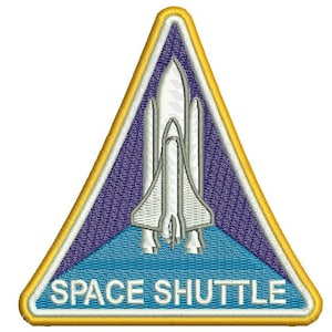 May include: Embroidered patch with a white space shuttle design on a blue and purple background. The patch is triangular with a gold border and the words "SPACE SHUTTLE" in white.