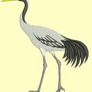 May include: A gray and black crane with a long neck and long legs. The crane has a yellow beak and a red crown on its head.